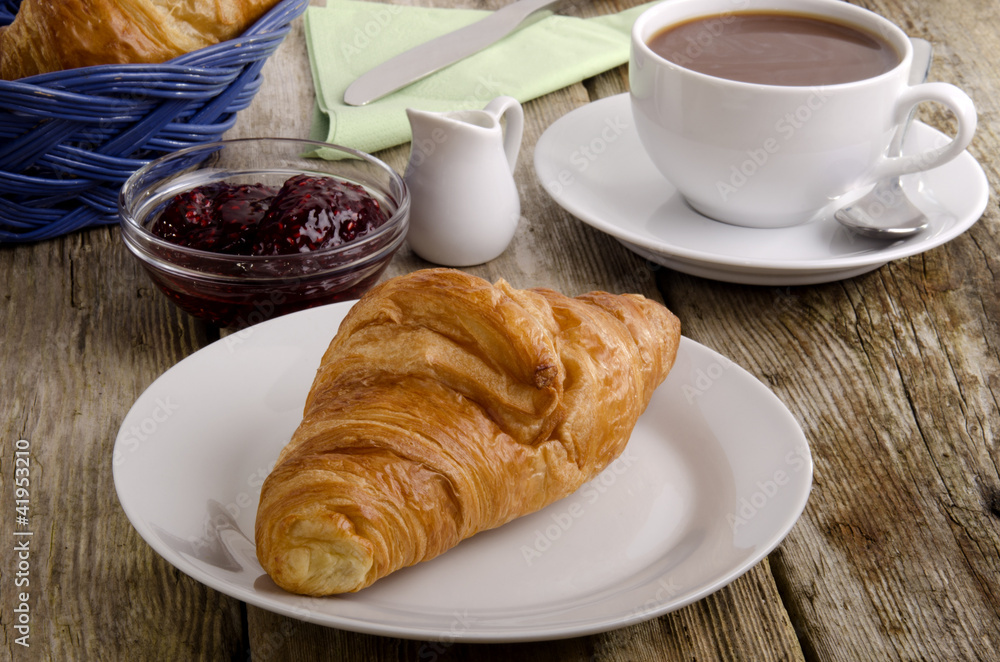 croissant, a French breakfast on a plate