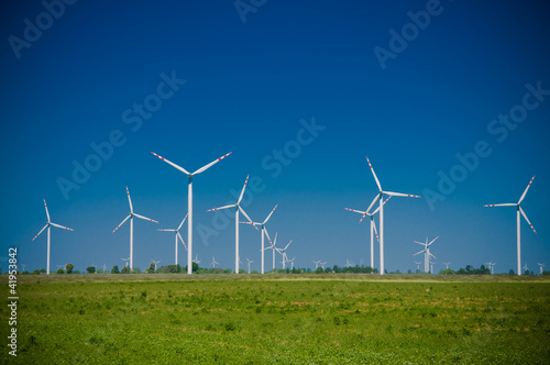 Wind turbine farm on rural terrain
