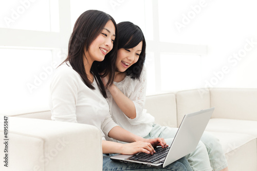 Beautiful young women using a laptop computer. Portrait of asian