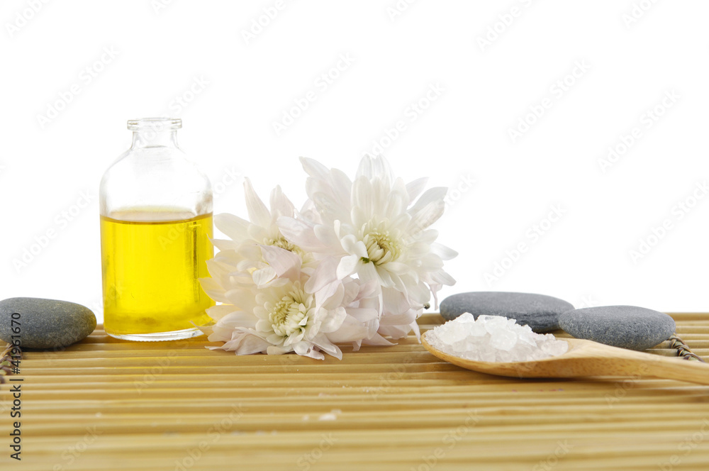 massage oil and salt in spoon with perfume bottle on mat