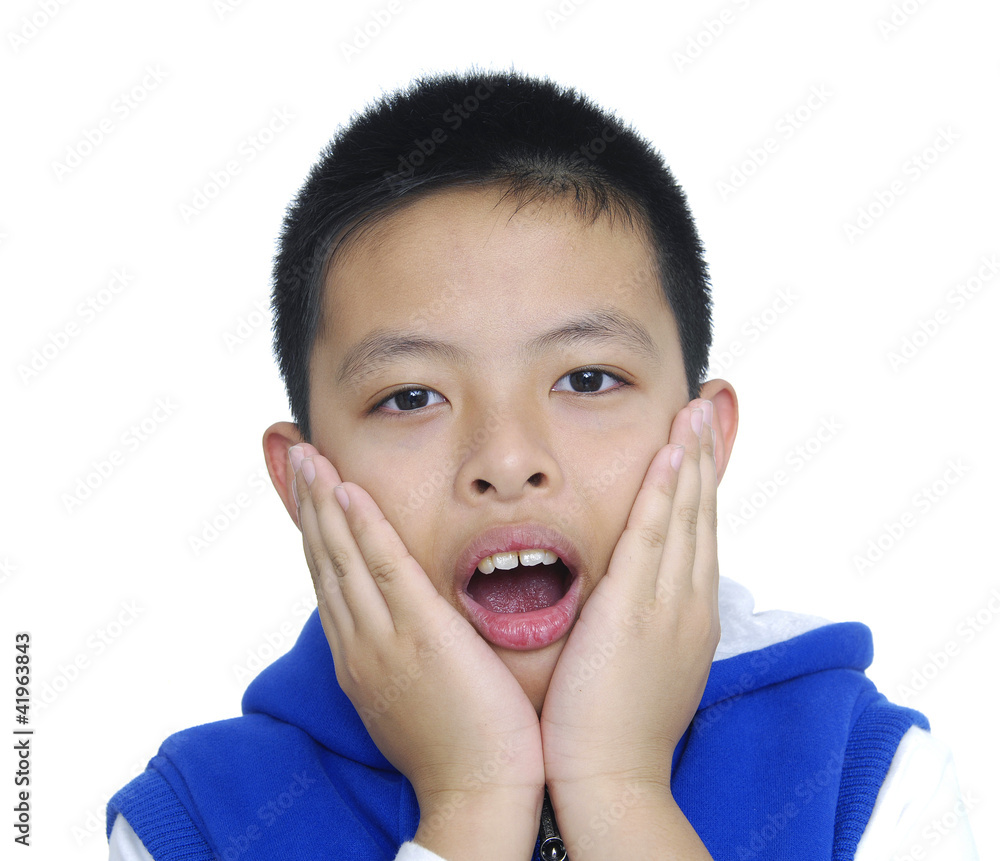 Child expressing surprise with his hands in his face Child expressing surprise with his hands in his face