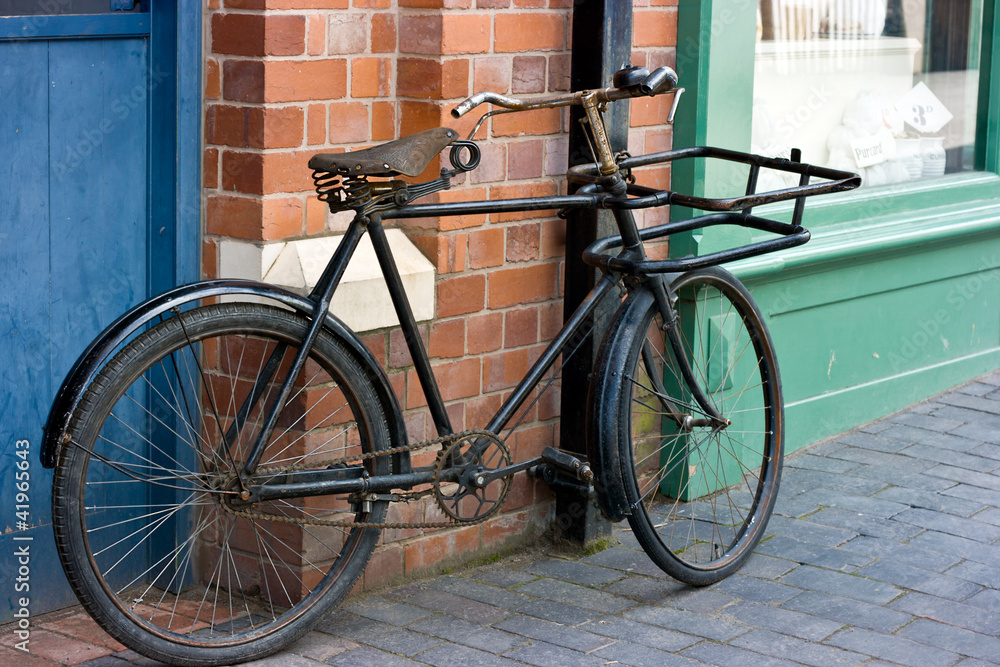 Old Victorian Bicycle Standing Outside A Shop Window. Old Victorian Bicycle Standing Outside A Shop Window.