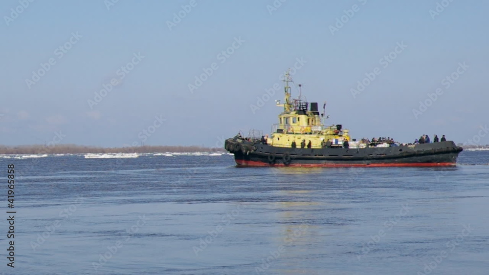 tug boat pushing through ice on a sunny springtime day tug boat pushing through ice on a sunny springtime day