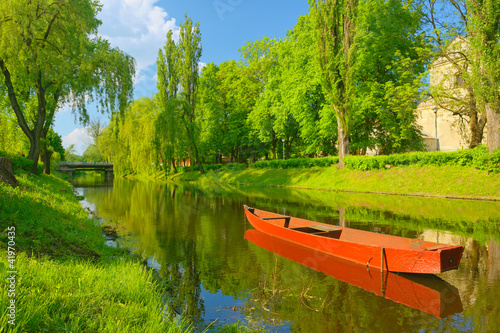 Spring landscape with boat on the river. photo