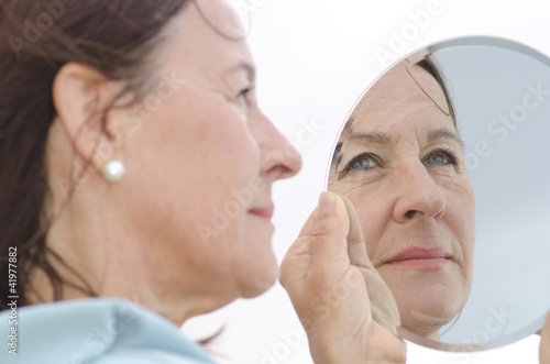 Portrait mature woman in mirror