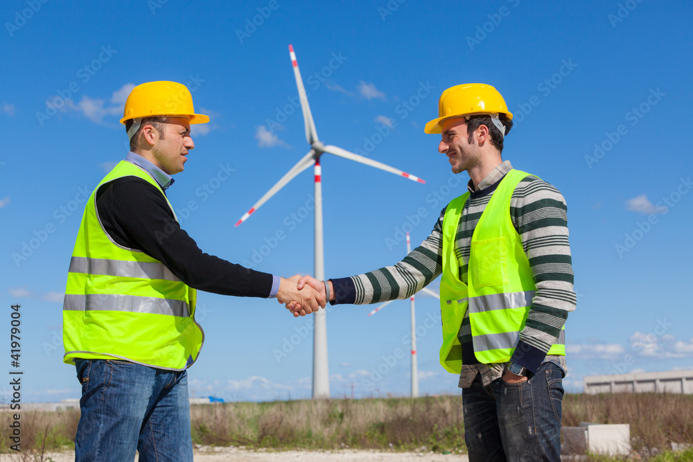 Engineers giving Handshake in a Wind Turbine Power Station Engineers giving Handshake in a Wind Turbine Power Station