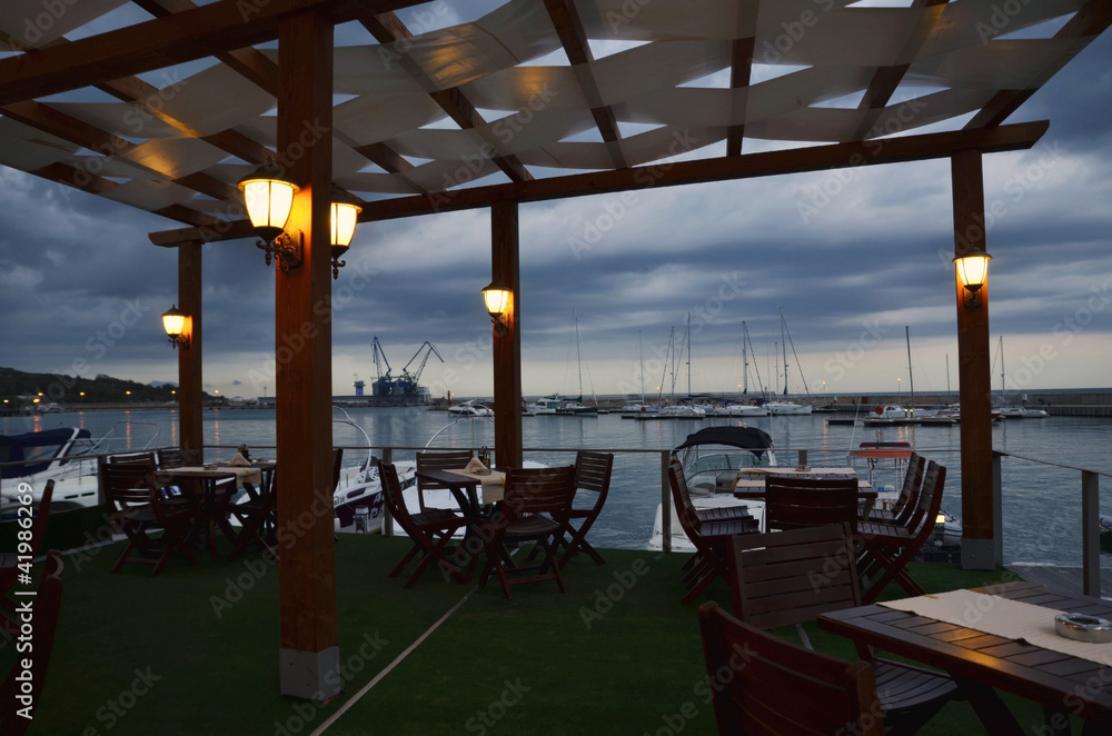 Idyllic cafe restaurant by the sea at Night  ,on wooden deck