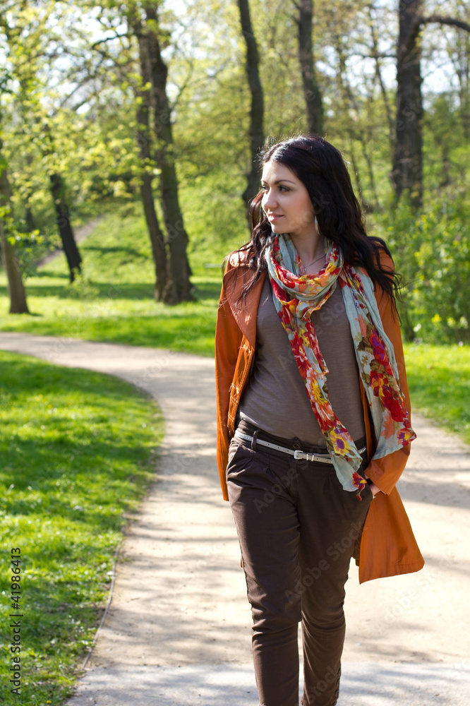 Fototapeta premium Young woman walking in a park