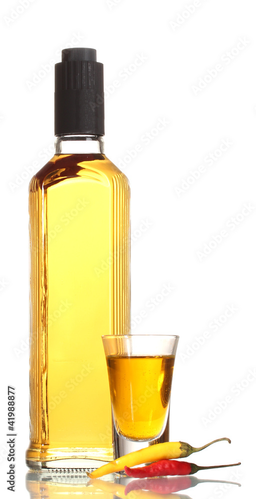 bottle and glass of pepper vodka and red chili peppers isolated bottle and glass of pepper vodka and red chili peppers isolated