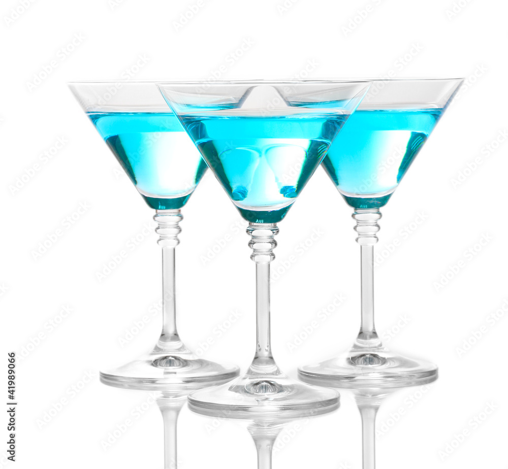 Blue cocktail in martini glasses isolated on white Blue cocktail in martini glasses isolated on white