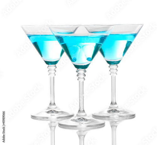 Blue cocktail in martini glasses isolated on white