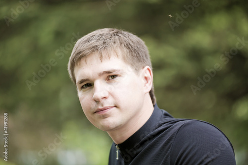 Portrait of the young man in park