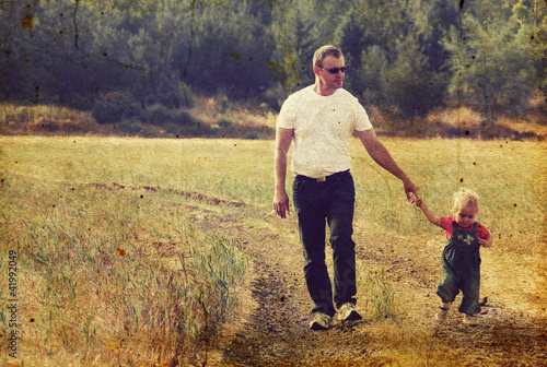 father and daughter in the autumn meadow. Photo in old image sty