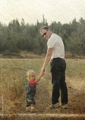 father and daughter in the autumn meadow. Photo in old image sty