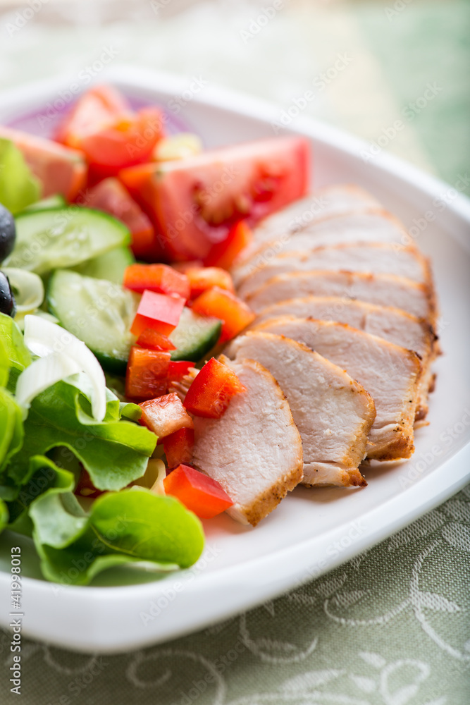 Chicken fillet with vegetable salad on a plate Chicken fillet with vegetable salad on a plate