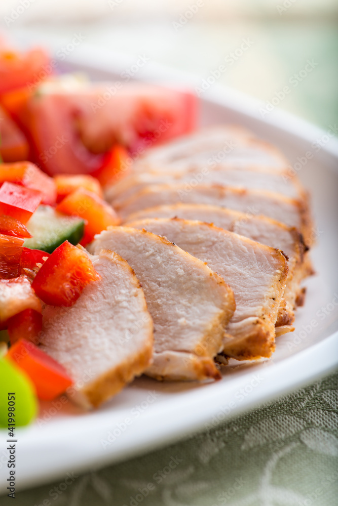 Closeup of chicken fillet with vegetable salad on a plate Closeup of chicken fillet with vegetable salad on a plate