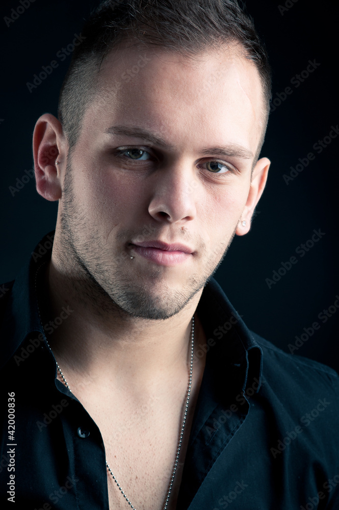 Young boy close up portrait against black background. Young boy close up portrait against black background.