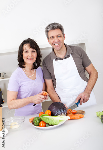 Senior couple cooking lunch at home