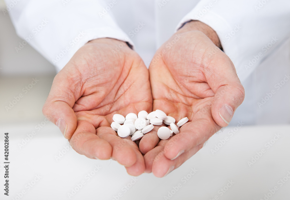 Doctor holding a pills in the hands Doctor holding a pills in the hands