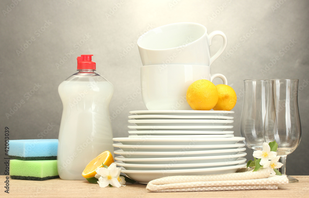 empty clean plates, glasses and cups with dishwashing liquid,
