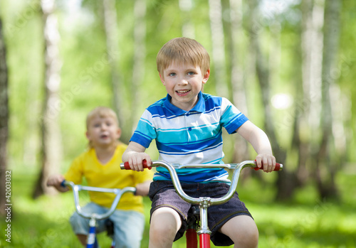 little children riding their bikes