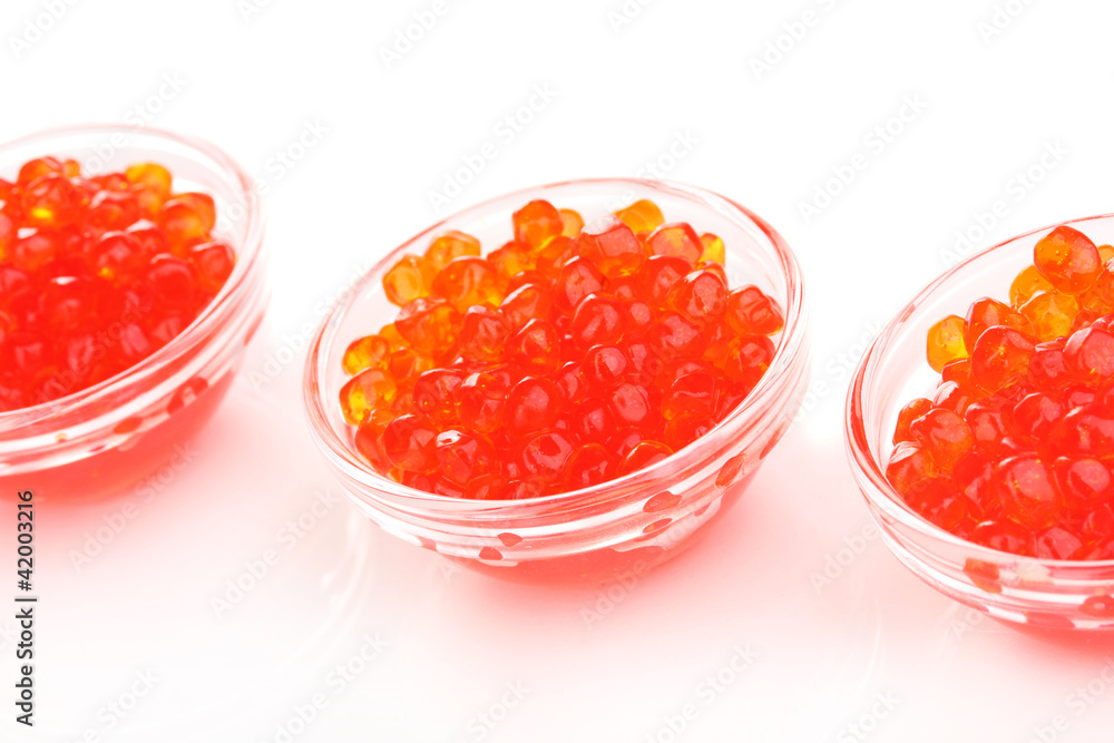 Red caviar in glass bowls isolated on white Red caviar in glass bowls isolated on white