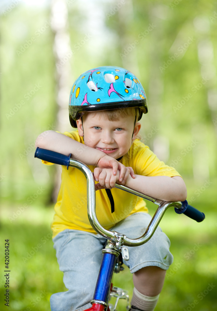 nice kid weared in helmet on bicycle nice kid weared in helmet on bicycle