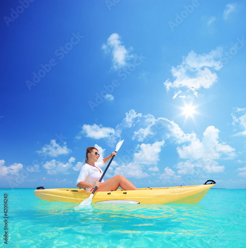 Woman kayaking on a sunny day  Kuredu island  Maldives