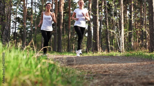 young women runnning in park, evening