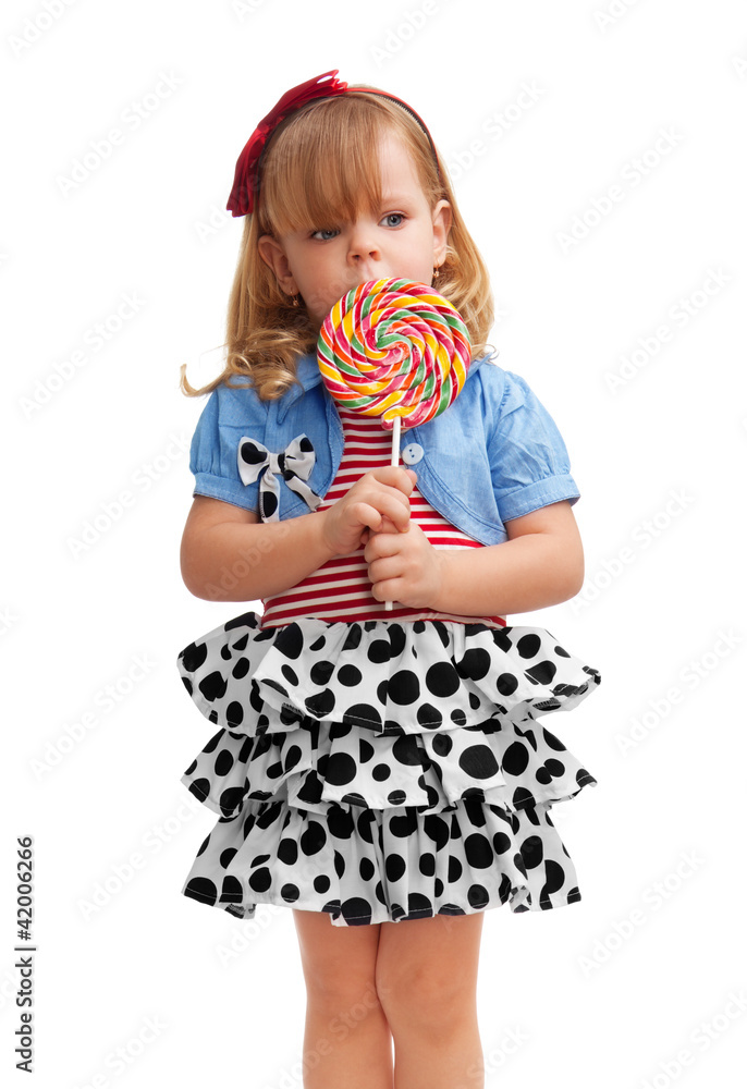 Small girl standing with lollipop