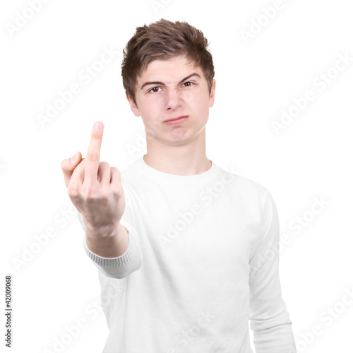 Angry teenager shows rude gesture on a white background