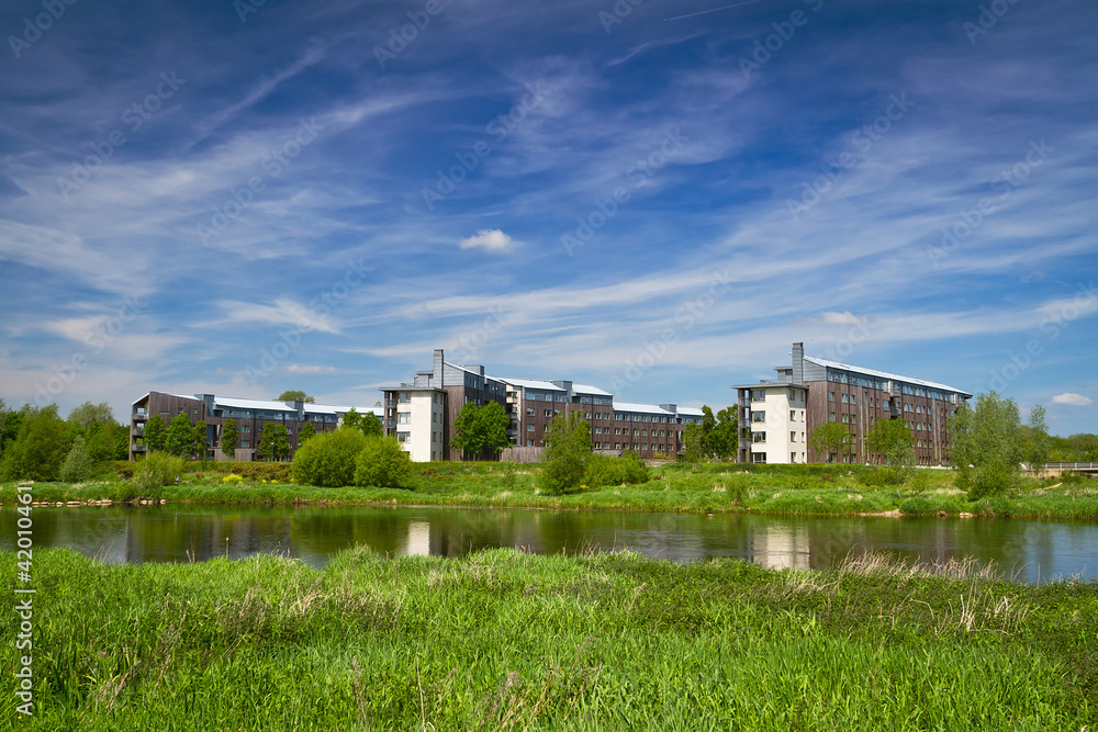 Apartments at the river in summer scenery
