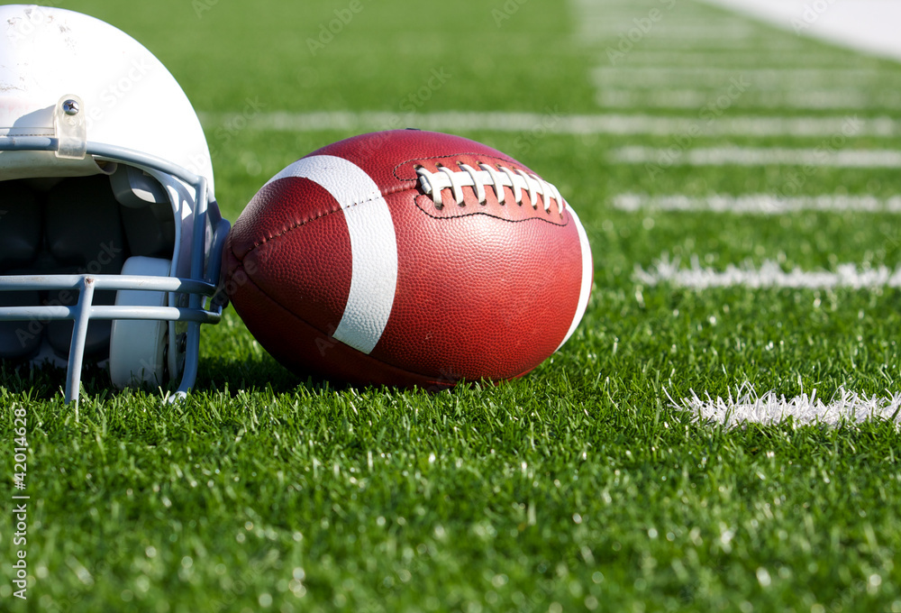 Football and Helmet on the Field Football and Helmet on the Field