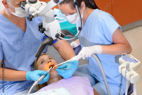Dentist operation patient through microscope