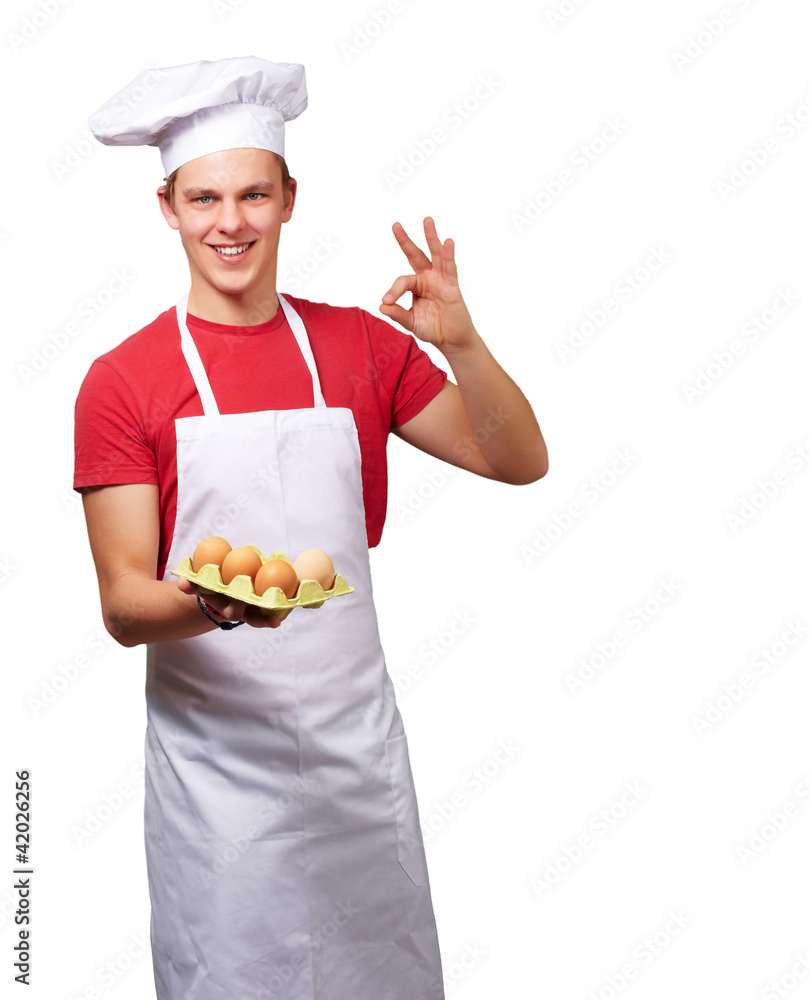 portrait of young cook man holding egg box and doing good gestur portrait of young cook man holding egg box and doing good gestur
