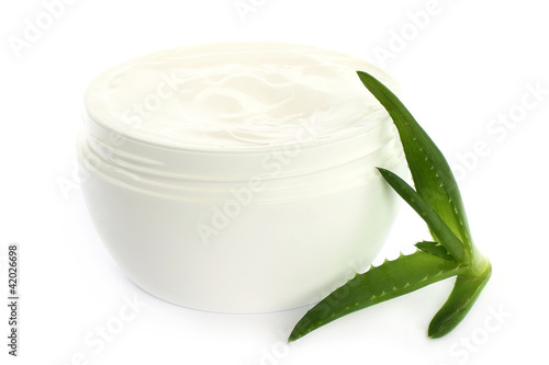 Open plastic container with cream and aloe on a white background