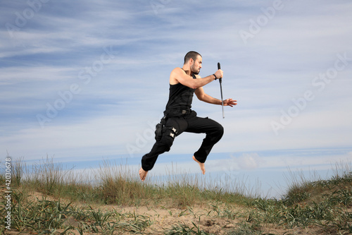 man with crowbar jumping