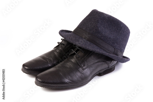 A pair of men's shoes and a classic hat