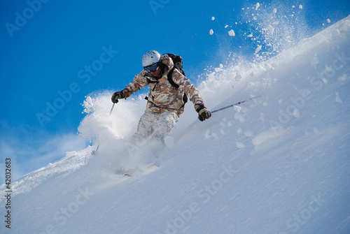 Tableau sur toile Skier in bright clothing, in deep snow