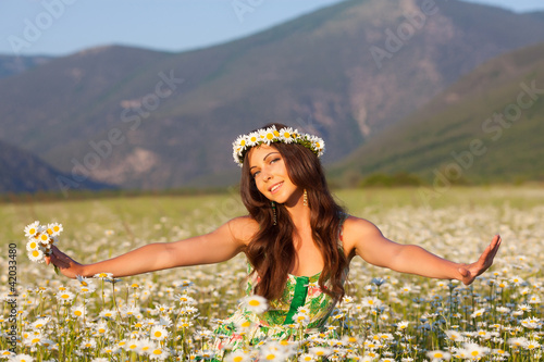 Girl on camomile field