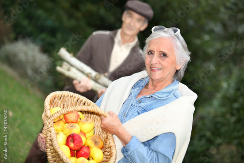 Elderly couple collecting objects in the forest