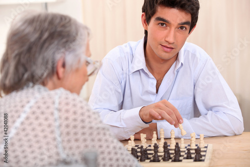 Grandmother and grandson playing chess