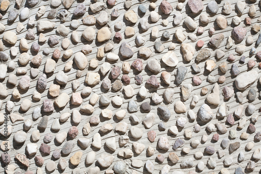 Little stones on a concrete wall Little stones on a concrete wall