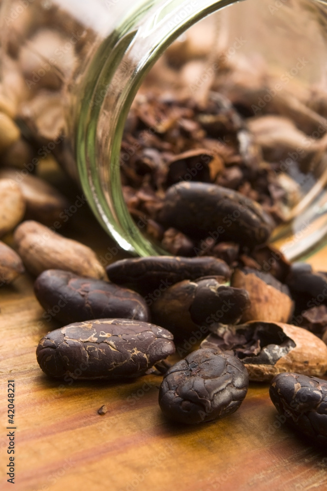 Obraz premium Cocoa (cacao) beans on natural wooden table