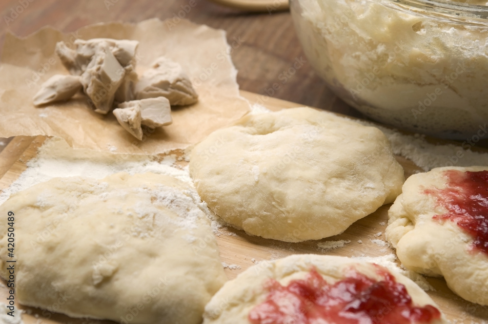 Dough with marmelade on wooden board Dough with marmelade on wooden board