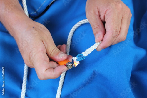 Bilde på lerret Rope Splicing and whipping hands using lighter to seal ropes
