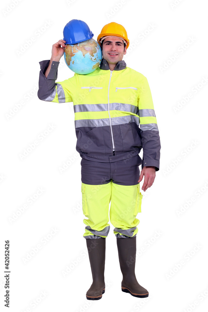 Manual worker stood with globe Manual worker stood with globe