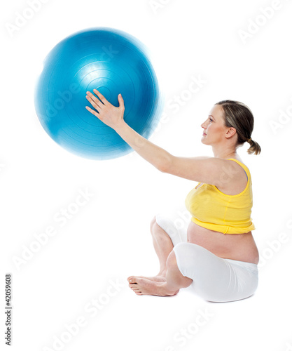 Attractive pregnant lady practicing yoga