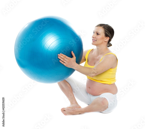 Pregnant woman excercises with a gymnastic ball