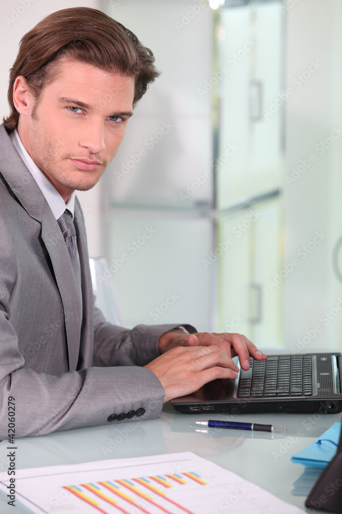 Young businessman on laptop